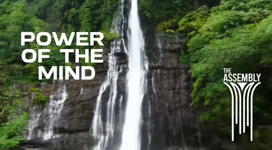 Archival video frame: waterfall, Power of the Mind title, and The Assembly's original white waterfall symbol
